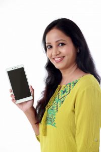 88978743 – young woman holding mobile phone against white background